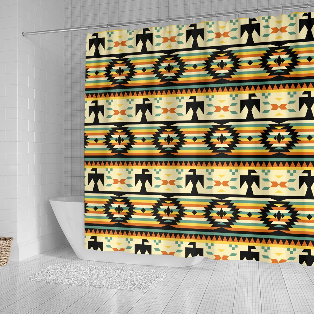 Yellow shower curtain featuring repeating black arrows, medallions, and orange-teal stripes