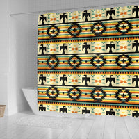 Yellow shower curtain featuring repeating black arrows, medallions, and orange-teal stripes