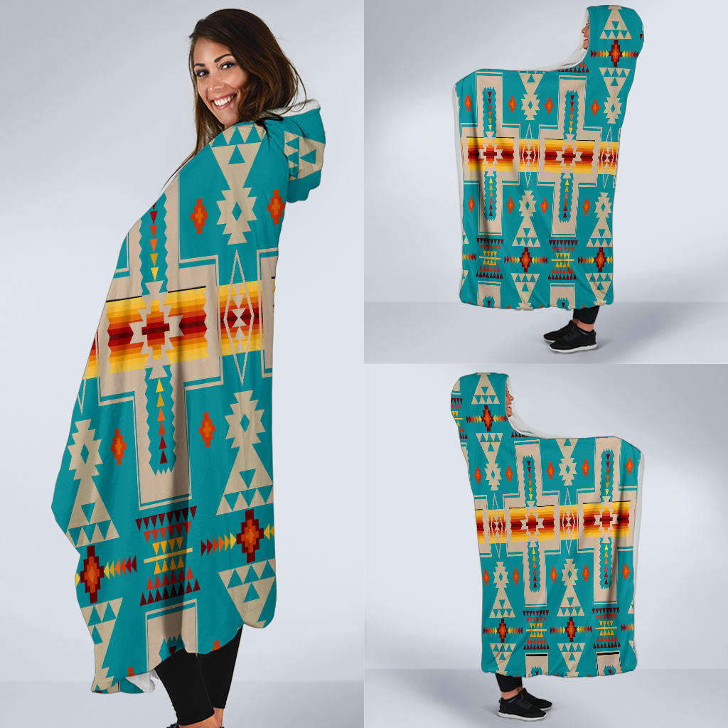 Turquoise hooded blanket wrap shown in hand, Native geometric design with multicolor accents