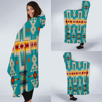 Turquoise hooded blanket wrap shown in hand, Native geometric design with multicolor accents