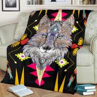 Stylized wolf face blanket draped on couch, black base with bright geometric shapes