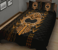 Black Polynesian quilt bed set with large golden heart emblem and matching pillow