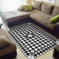 Black-and-white checkered rug with centered compass star and decorative edge trim