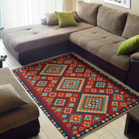 Multicolor geometric area rug with teal, yellow, and red shapes and navy border