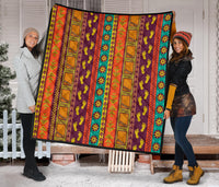Multicolor full quilt featuring Native-inspired vertical panel patterns and decorative icons