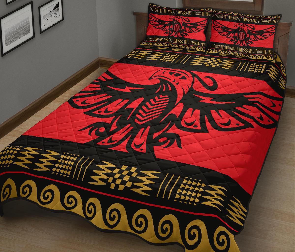 Red quilt bed set with large eagle centerpiece, black field, and gold pattern trim