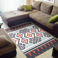 Colorful tribal area rug with white center, navy stripes, orange shapes, and border