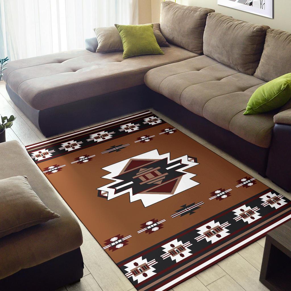 Rust geometric area rug with central white starburst motif and repeating symbols border
