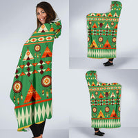 Multicolor Native-style bison hooded blanket draped over shoulders, green background