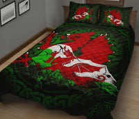 Green quilt with red dragon and large white emblem, two matching decorative pillows