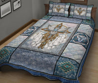 Quilt and shams featuring central owl dreamcatcher design with teal ring accents, blue border