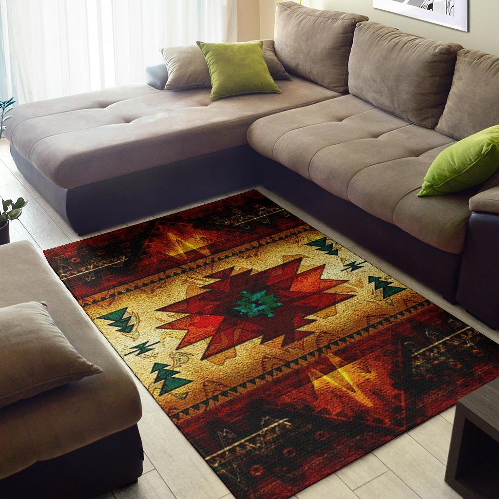 Geometric area rug in red, gold, green and teal with dark patterned border under sofa