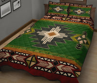 Green quilt bed set with starburst center and matching pillow shams, tribal pattern