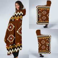 Multicolor geometric hooded blanket draped for wear with diamond motifs and trim