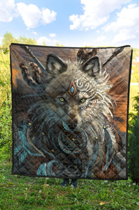 Quilt featuring a large wolf portrait in gray, brown, and turquoise with decorative pattern