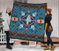 Native American style blue quilt featuring dreamcatcher graphic with multicolor bead details.