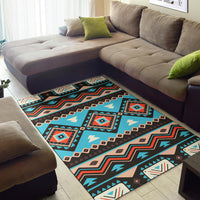 Turquoise and dark geometric tribal pattern area rug laid on living room floor
