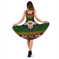 Sleeveless dress back view, green and black with tan and red geometric print