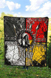 Multicolor Chief Arrow quilt with red, yellow, and black sections and feather-arrow motifs
