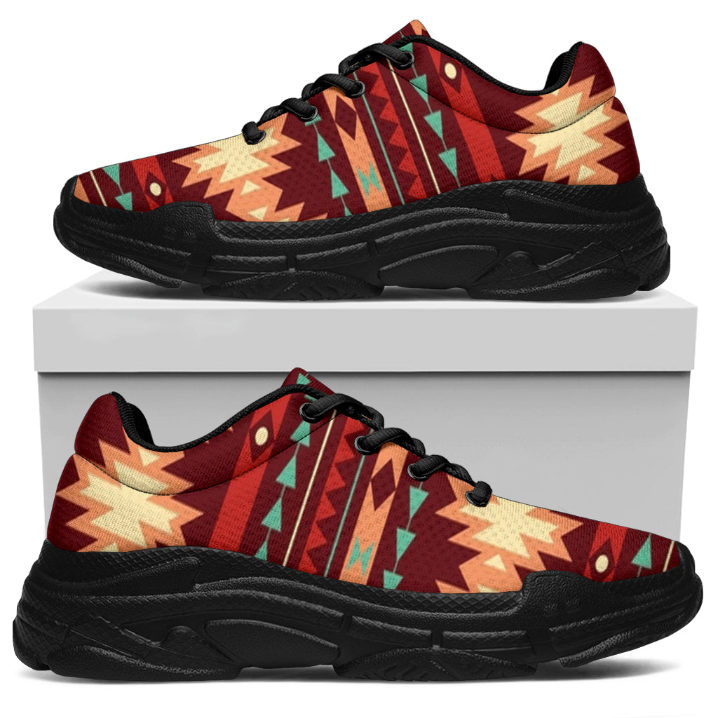 Red tribal pattern chunky sneakers side view, black sole and lace-up front