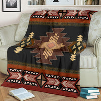 Geometric blanket with central star motif, black and brown design with red trim