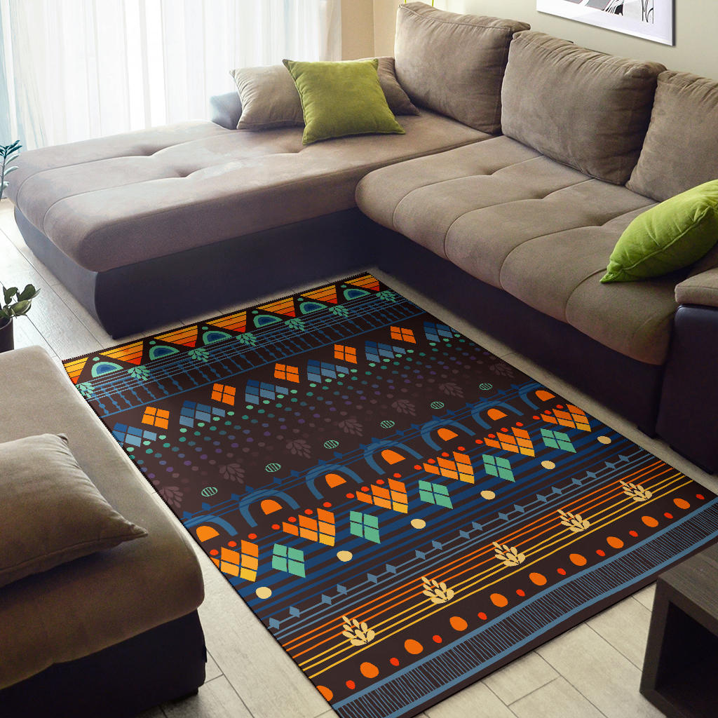 Area rug with multicolor geometric pattern in navy blue, orange blocks, and green accents