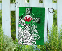 Green house flag featuring Welsh dragon emblem over Celtic cross with knot patterns
