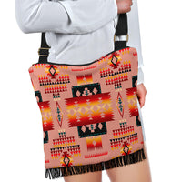 Colorful tribal crossbody bag on model, black strap with gold buckle, tassel trim