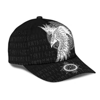 Black cap side view with white raven tattoo and circular emblem