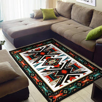 Flat woven area rug, black ground with bold white center starburst and red/teal trim