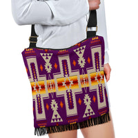 Colorful geometric crossbody bag in purple with fringe bottom and gold-tone buckle strap.
