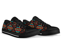 Pair of low-top sneakers with black uppers and teal, red, and yellow Native-inspired print.