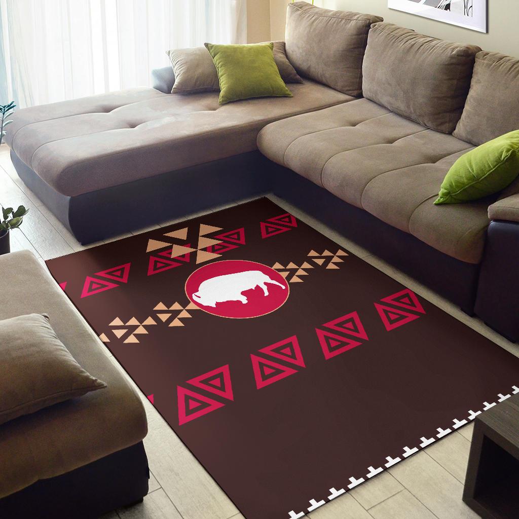 Brown bison area rug with red/pink triangle pattern and beige accents, stitched edge border