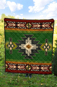 Green geometric quilt with central starburst, brown-orange band, and red trim