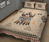 Close view quilt top with central bison head, geometric triangles, and teal/red border