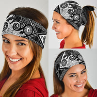 Black/white viking bandana worn across forehead, geometric tribal medallion