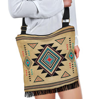 Crossbody tote-style bag in tan with colorful southwest symbols, zip top, and black strap