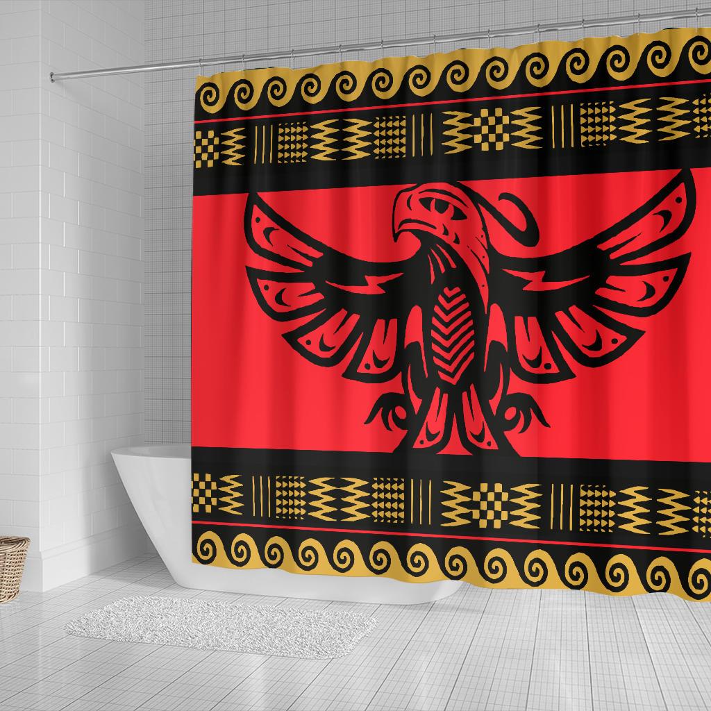 Red shower curtain showing black eagle wings graphic, gold patterned trim