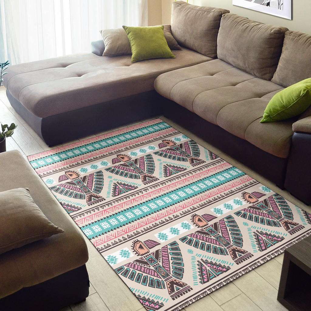 Tribal area rug in pink, teal, and cream with geometric medallion motif