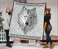 White quilt blanket with black edging and detailed grayscale wolf face design