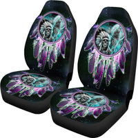 Pair of car seat covers with oval dreamcatcher skull art on dark fabric, colorful trim