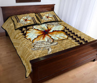 Beige quilt bed set with hibiscus and sea turtle motifs, two printed pillows