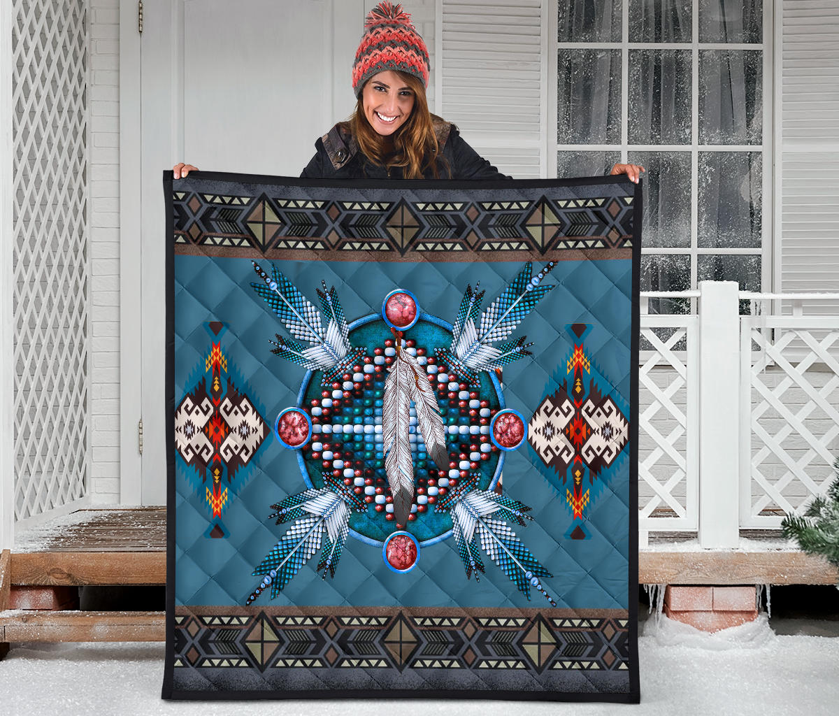 Blue quilt with dreamcatcher medallion, feather details, and multicolor geometric side panels.