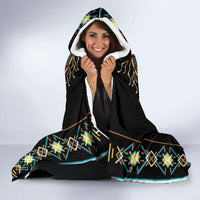 Black hooded blanket with white sherpa-like hood lining and wolf dreamcatcher design