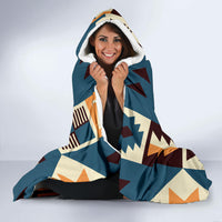 Navy hooded blanket wrapped up with hood, white sherpa lining visible