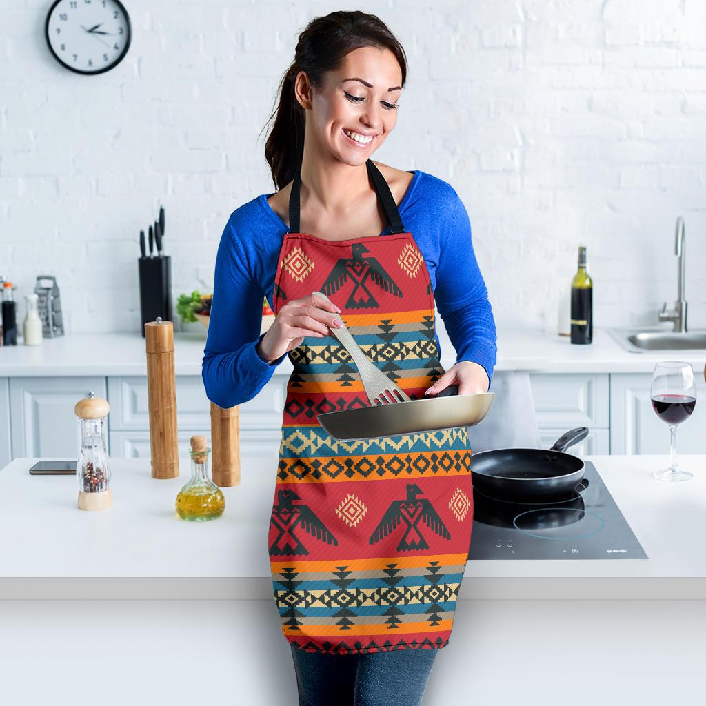Multicolor geometric apron worn with black neck and waist straps
