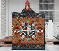 Native pattern brown quilt featuring turquoise bead circles around a white feather motif