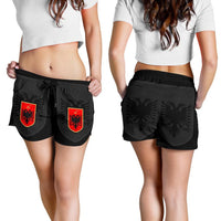 Black women’s shorts on model with elastic waistband, tie, and red Albanian crest panels
