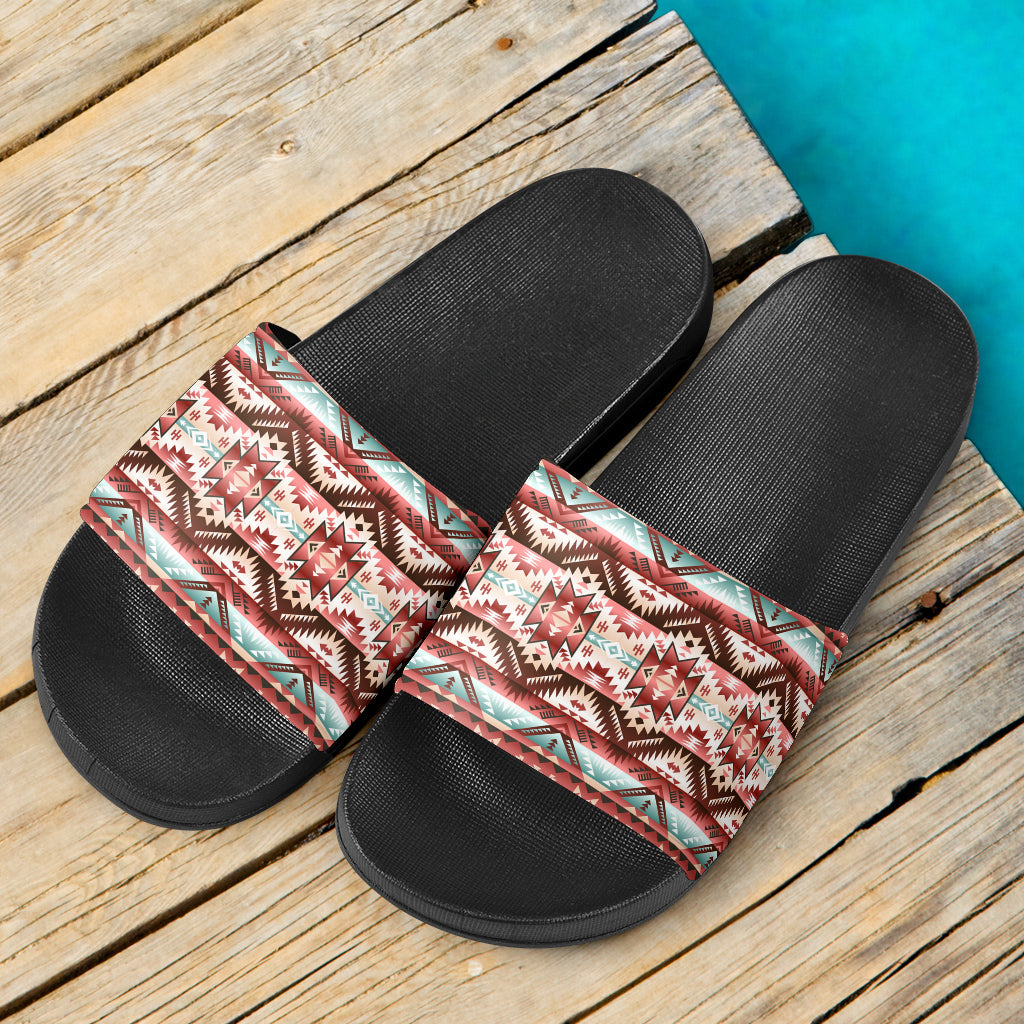 Pair of red patterned slide sandals, black footbed and textured sole