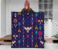 Blue Native-inspired quilt with multicolor thunderbird and arrow patterns, laid flat